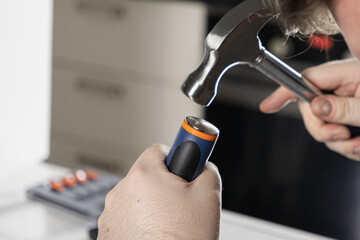 Naklejka premium man using a hammer for a diy home repair project, close-up on hands and tools in a workshop setting