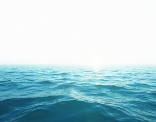 Horizon view of bright blue wavy sea, cloudless white sky. Seascape with calm turquoise water reflecting sunlight. Summer nature background for travel, vacation, marine themes. Perfect for meditation.