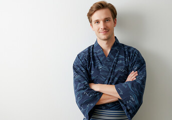 A white man wearing a yukata with his arms crossed- traditional attire
