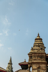 Fototapeta premium Nepal Kathmandu historical center with its temples and architecture and blue sky where the plane flies