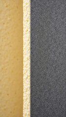 Fototapeta premium Close-up view of acoustic foam panels with different colors, highlighting the texture and appearance of soundproofing material.