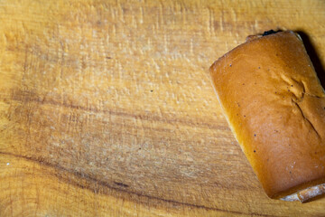 Delicious bakery bun resting on a wooden cutting board