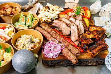 Delicious spread of grilled meats and festive appetizers on a platter