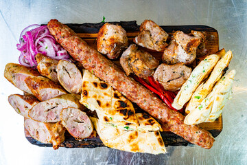 Delicious assortment of grilled meats with flatbread and toppings