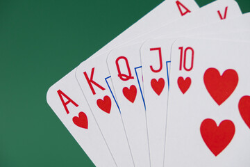royal flush in hearts suit on a green background, ideal for poker strategy guides, casino marketing, gambling blogs