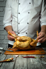 A skilled chef places a well-seasoned whole chicken on a wooden cutting board, surrounded by garlic and spices. The atmosphere is warm, highlighting the art of gourmet cooking