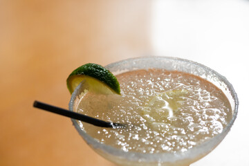 Margarita cocktail in a glass glass on a blurred background