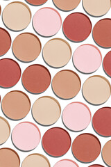Eyeshadow palette, mix of matte shades in neutral beige brown hues. Minimal view pattern for beauty, makeup, cosmetic themes, Vivid nude skintone colored swatches eyeshade refills round shape