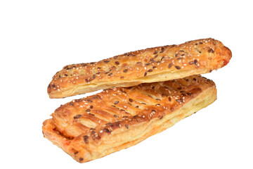 Puff pastry cake with filling and sesame seeds lies on a white background.
