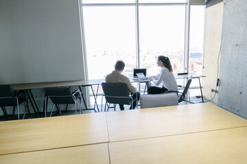 Two business office workers in office building