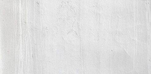 White concrete wall background texture showing brush strokes and imperfections