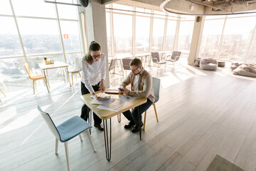 Brainstorming by two people in office