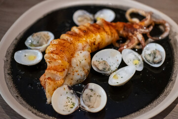 Arroz negro calamari paella, a Spanish dish made with squid ink, rice, and seafood