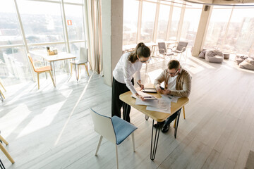 Brainstorming by two people in office