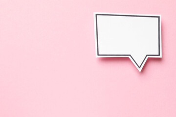 Blank speech bubble on light pink background, top view. Space for text