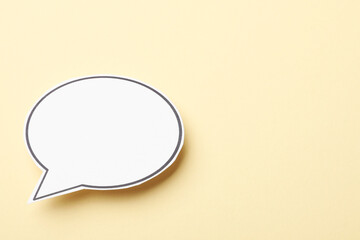 Blank speech bubble on beige background. Space for text