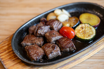 Diced meat steak served on plate with various vegetable