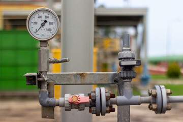 Close-up of  chemical industrial pressure gauge and valves. Piping system detail