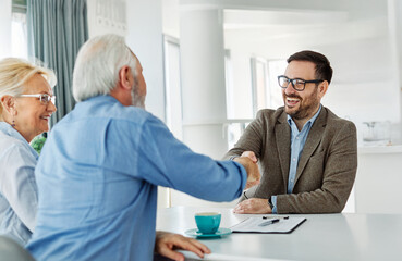 meeting agreement investment couple contract handshake advice retirement consultation senior elderly document deal insurance finance signing