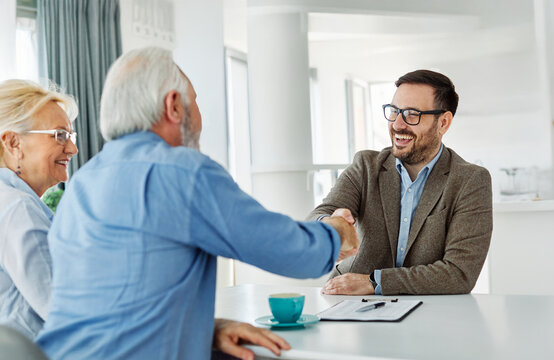 meeting agreement investment couple contract handshake advice retirement consultation senior elderly document deal insurance finance signing - Powered by Adobe
