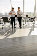 Two office workers working to together 