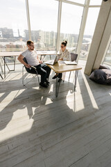 Two office workers working to together 