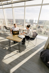 Two office workers working to together 