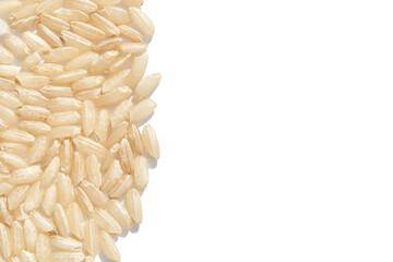 Close up of uncooked brown rice grains on white background.