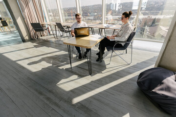 Two office workers working to together 