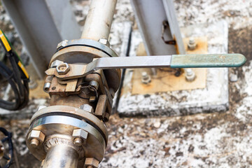 Close-up of an industrial chemical pipe valve with a wrench. Industrial infrastructure