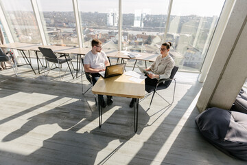 Two office workers working to together 