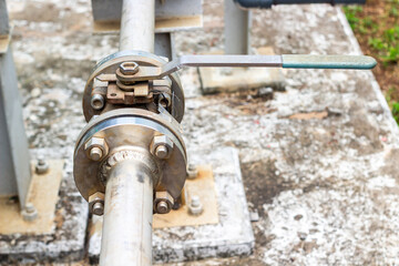 Close-up of an industrial chemical pipe valve with a wrench. Industrial infrastructure