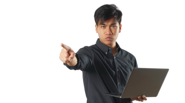 Serious asian freelancer pointing finger holding laptop with transparent background