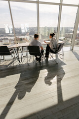 Two office workers working to together 