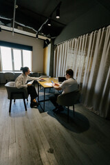 Two office workers working to together 