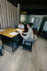 Two office workers working to together 
