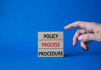 Policy Process Procedure symbol. Concept words Policy Process Procedure on wooden blocks. Businessman hand. Beautiful blue background. Business concept and Policy Process Procedure. Copy space.