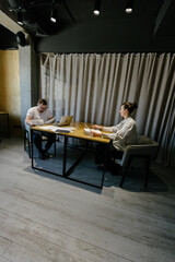 Two office workers working to together 