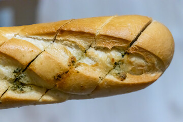 Freshly baked bread with textured crust displayed on a neutral background. Perfect for culinary themes, bakeries, and food photography