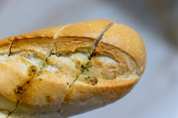 Close-up of freshly baked bread roll with a golden crust and visible texture, perfect for food concepts and culinary presentations