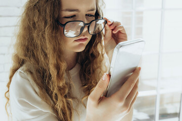 Poor vision. Young woman with glasses, girl with poor vision on white background