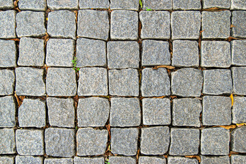 A top view of gray granite paving stone tiles surface texture