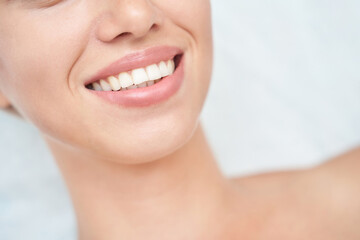 Obraz premium Close up of smiling caucasian female with perfect teeth and smooth skin.