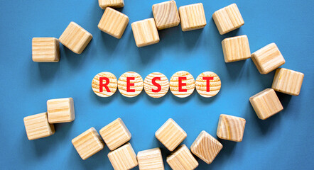 Reset symbol. Concept word Reset on beautiful wooden circles. Beautiful blue table blue background....