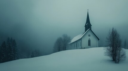 A snow covered church sits amidst the foggy landscape