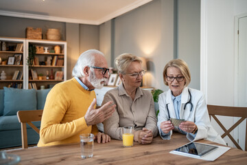 Doctor explaining medication to a senior couple