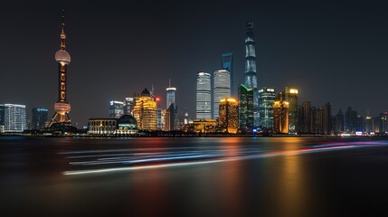 Obraz premium Night cityscape skyline with illuminated skyscrapers and river.