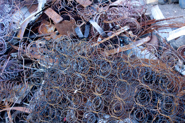 Pile of rusty metal springs, industrial waste, and scrap.