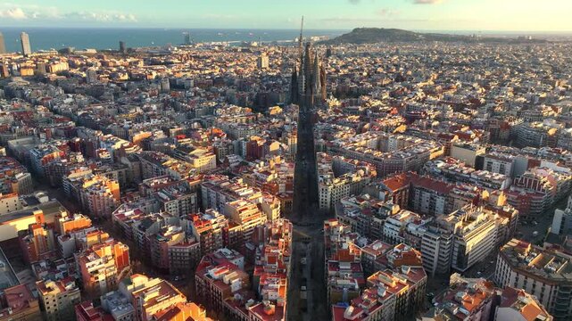 Sunset drone shot of downtown Barcelona with famous Barcelona octagon street pattern and cathedral, travel in Barcelona, Spain
