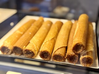 Treat yourself to our sweet waffles, which you can enjoy at any time of the day or night. An incredibly appetizing showcase with crispy, beautifully rolled waffles filled with delicious sweetness